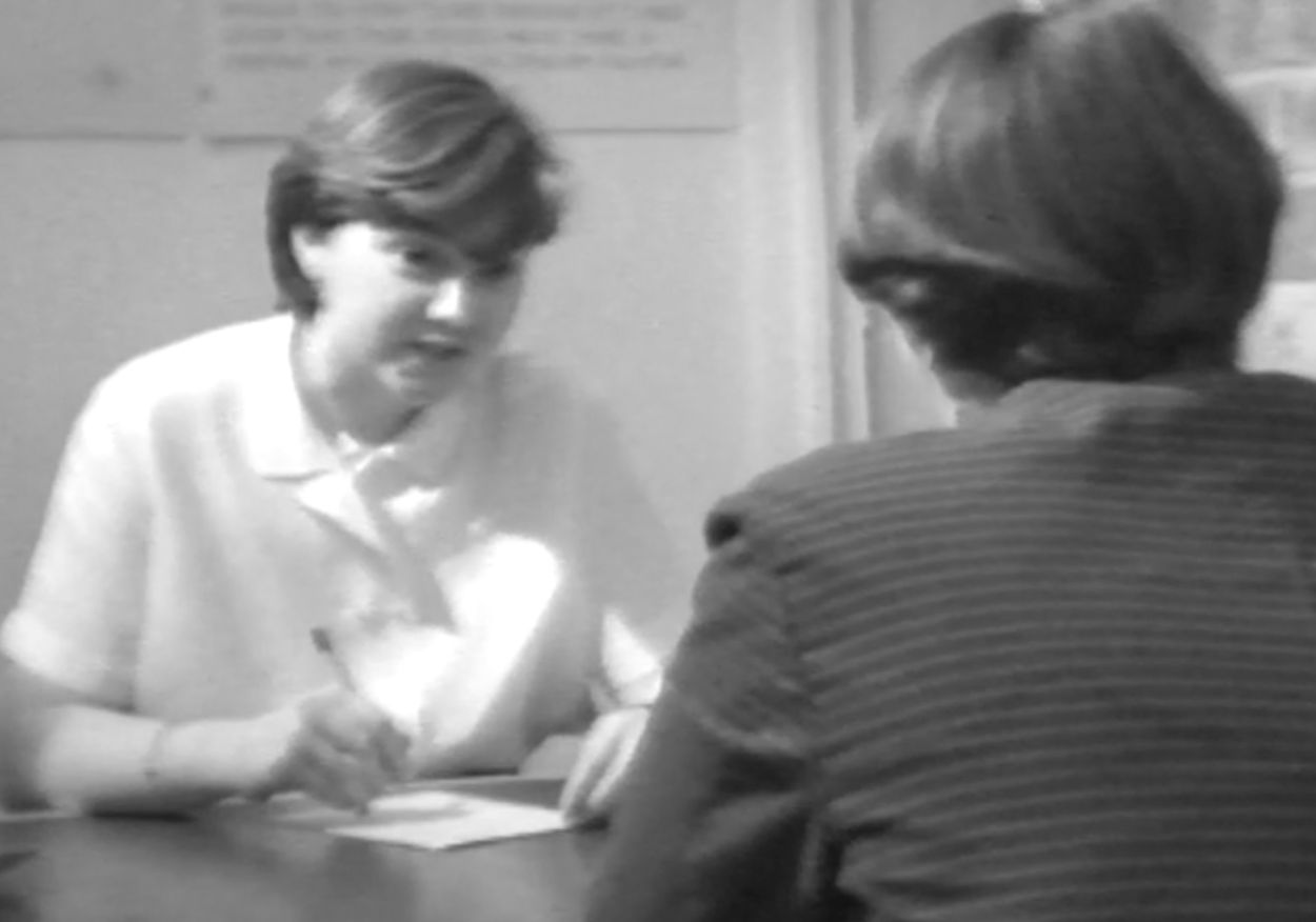 woman interviewed for a job sat at a desk.