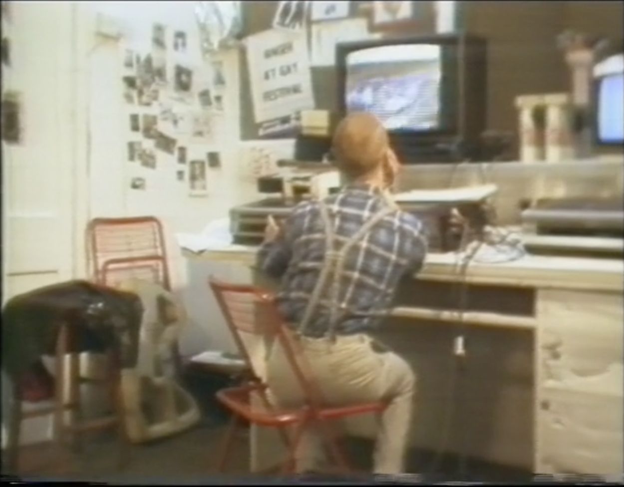 1980s, person sitting at a video editing desk.